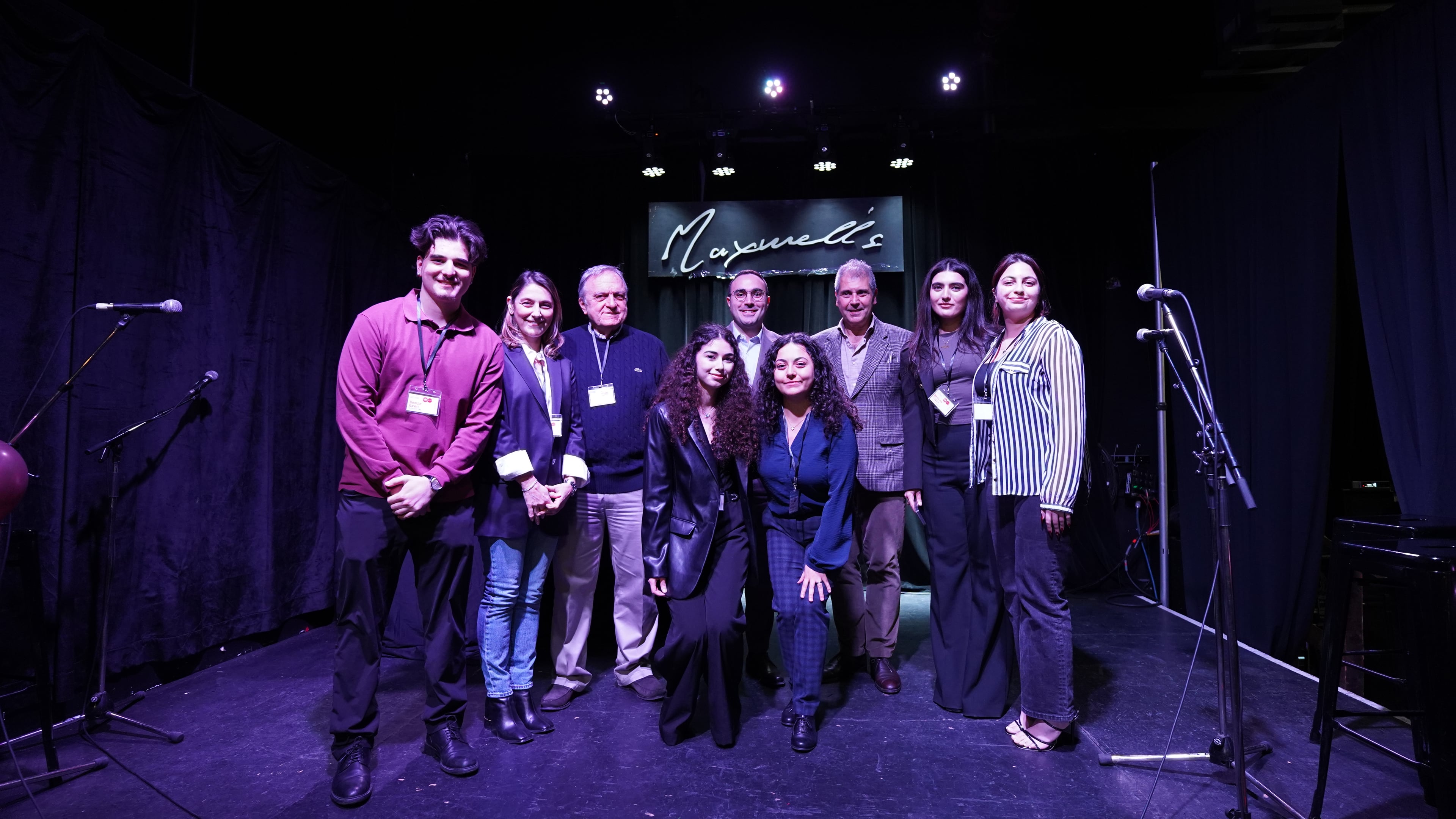 All panelists and organizers on stage at Maxwell's